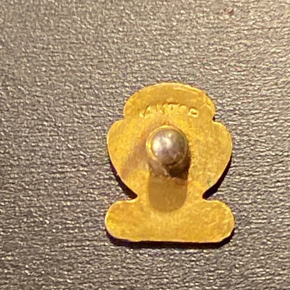 Set of 2 gold pins for city services one marked 14k on 10k one with a diamond